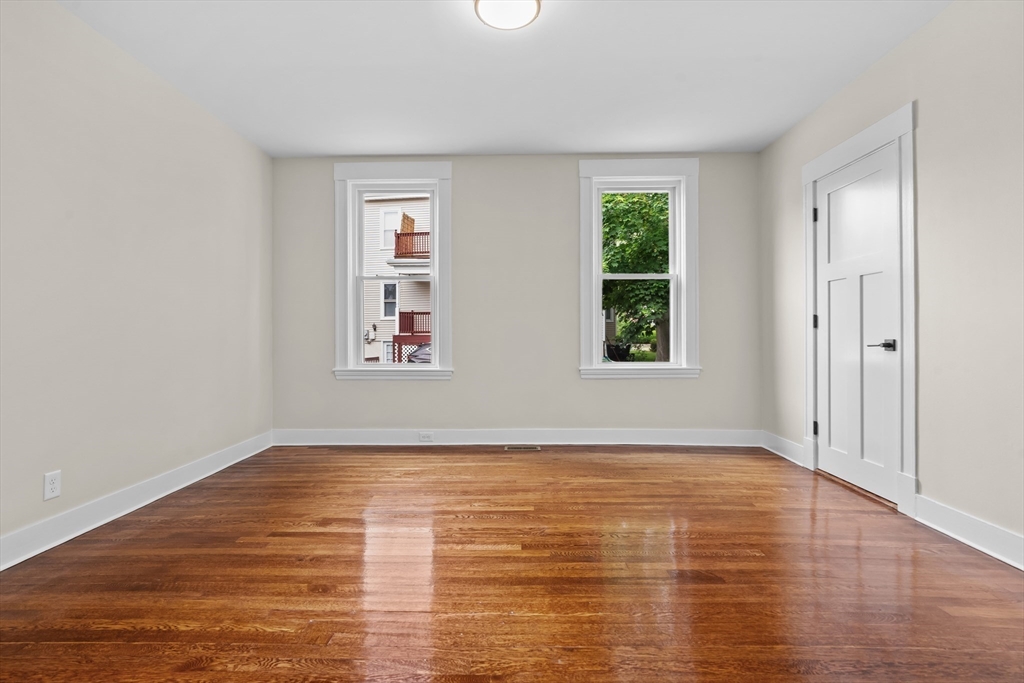 35 George Street, Unit 35 Newton, MA 02458 - Photo 4 of 36 a view of an empty room with window and wooden floor