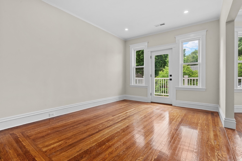 35 George Street, Unit 35 Newton, MA 02458 - Photo 6 of 36 an empty room with wooden floor and windows
