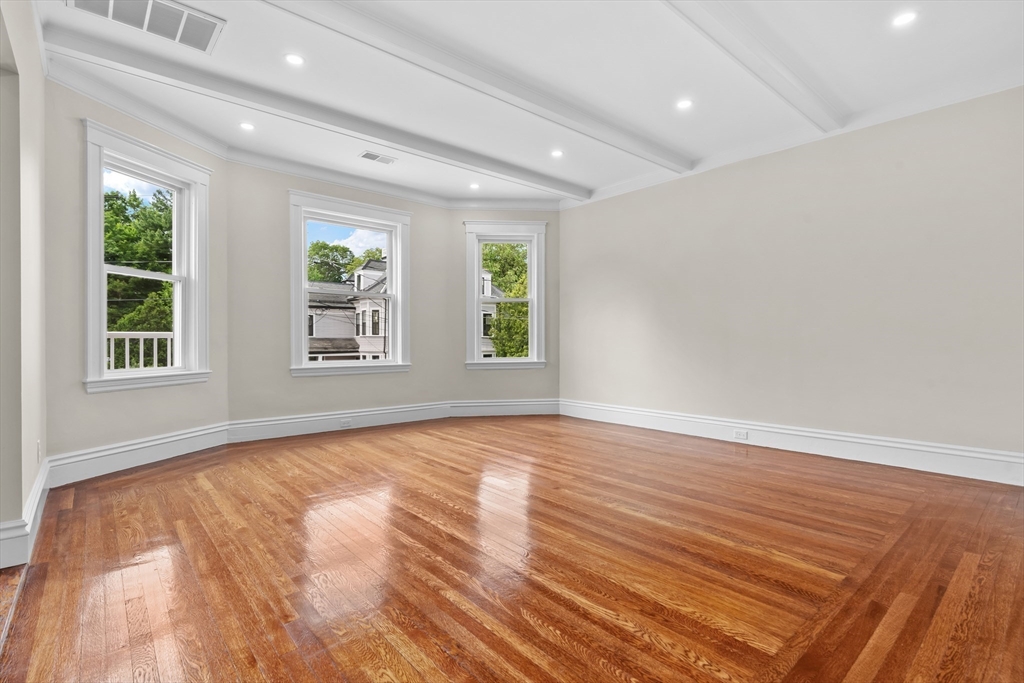 35 George Street, Unit 35 Newton, MA 02458 - Photo 7 of 36 a view of an empty room with wooden floor and a window