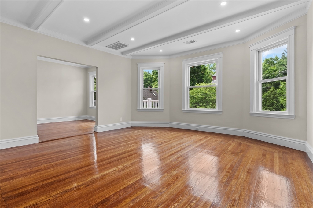 35 George Street, Unit 35 Newton, MA 02458 - Photo 8 of 36 a view of an empty room with wooden floor and a window