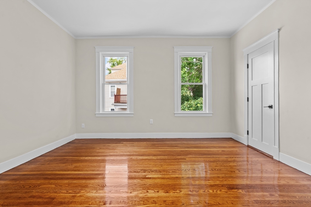 35 George Street, Unit 35 Newton, MA 02458 - Photo 9 of 36 a view of an empty room with window and wooden floor