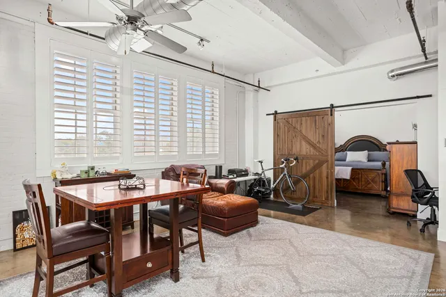 a dining room with furniture and a chandelier