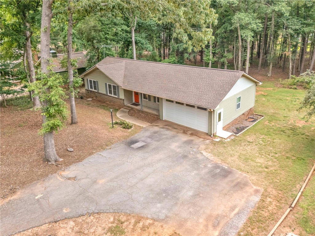 4416 Denver Cove Road Anderson, SC 29625 - Photo 31 of 31 A classic ranch home nestled among a lush, wooded landscape offers a serene retreat.