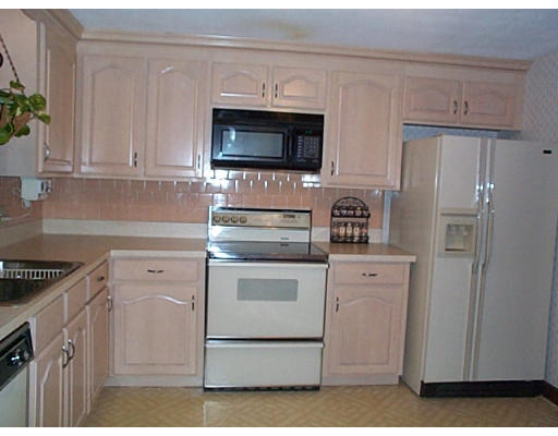 3 Coe Road Framingham, MA 01701 - Photo 3 of 8 a kitchen with white cabinets and stainless steel appliances