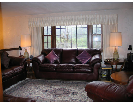 3 Coe Road Framingham, MA 01701 - Photo 5 of 8 a living room with furniture and a lamp