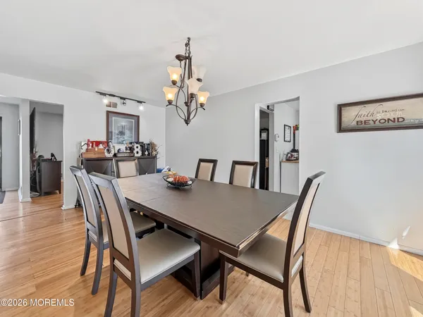 a view of a dining room with furniture and wooden floor