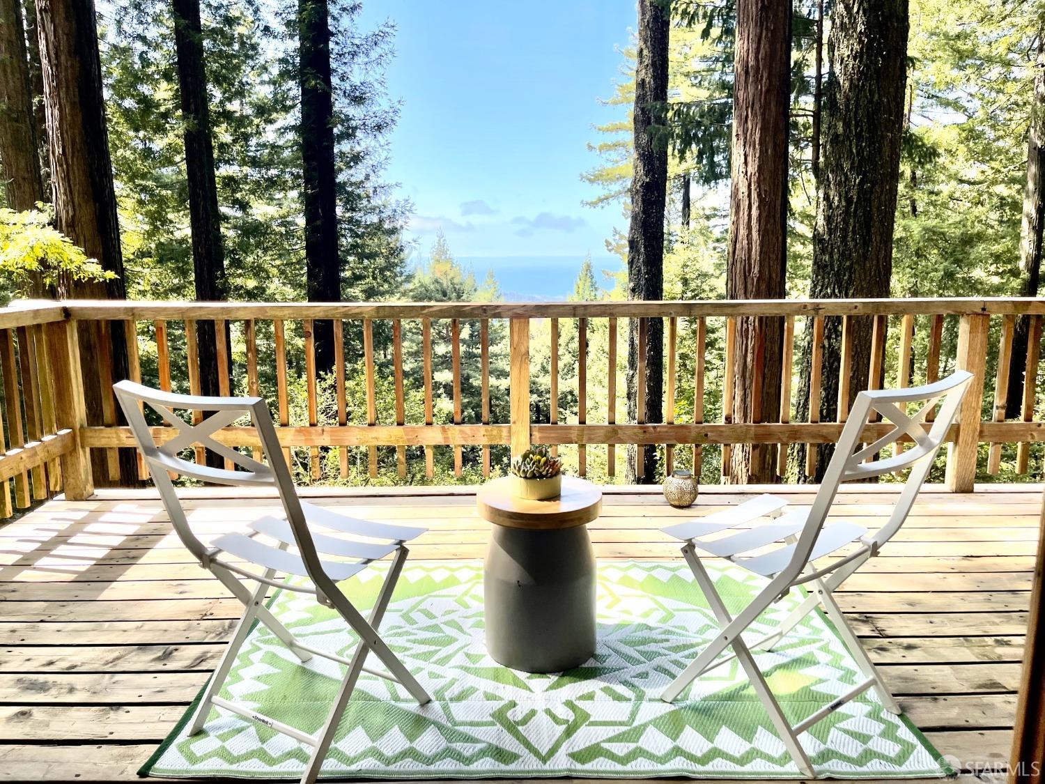 112 Marine Road Woodside, CA 94062 - Photo 1 of 22 a view of a balcony with chairs and wooden floor