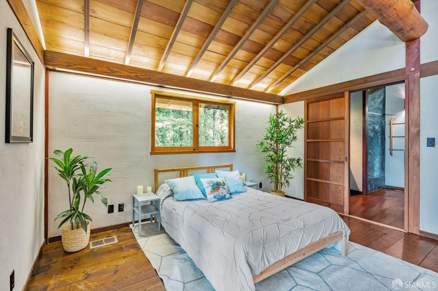 112 Marine Road Woodside, CA 94062 - Photo 11 of 22 a bedroom with a large bed and a potted plant