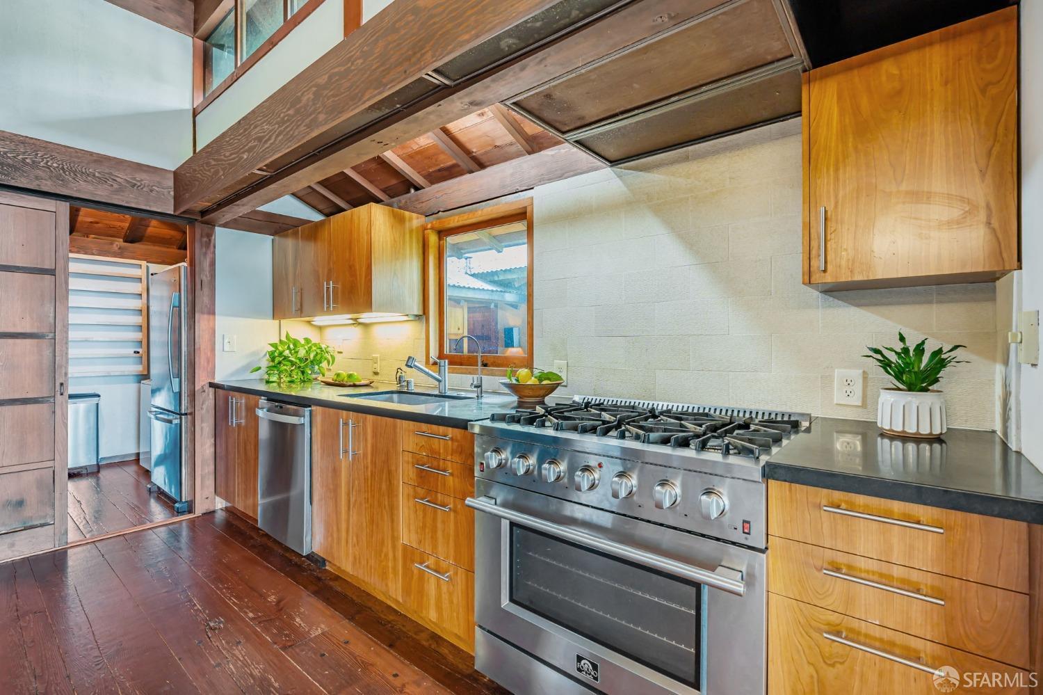 112 Marine Road Woodside, CA 94062 - Photo 7 of 22 a kitchen with stainless steel appliances a stove a chimney a sink and wooden cabinets