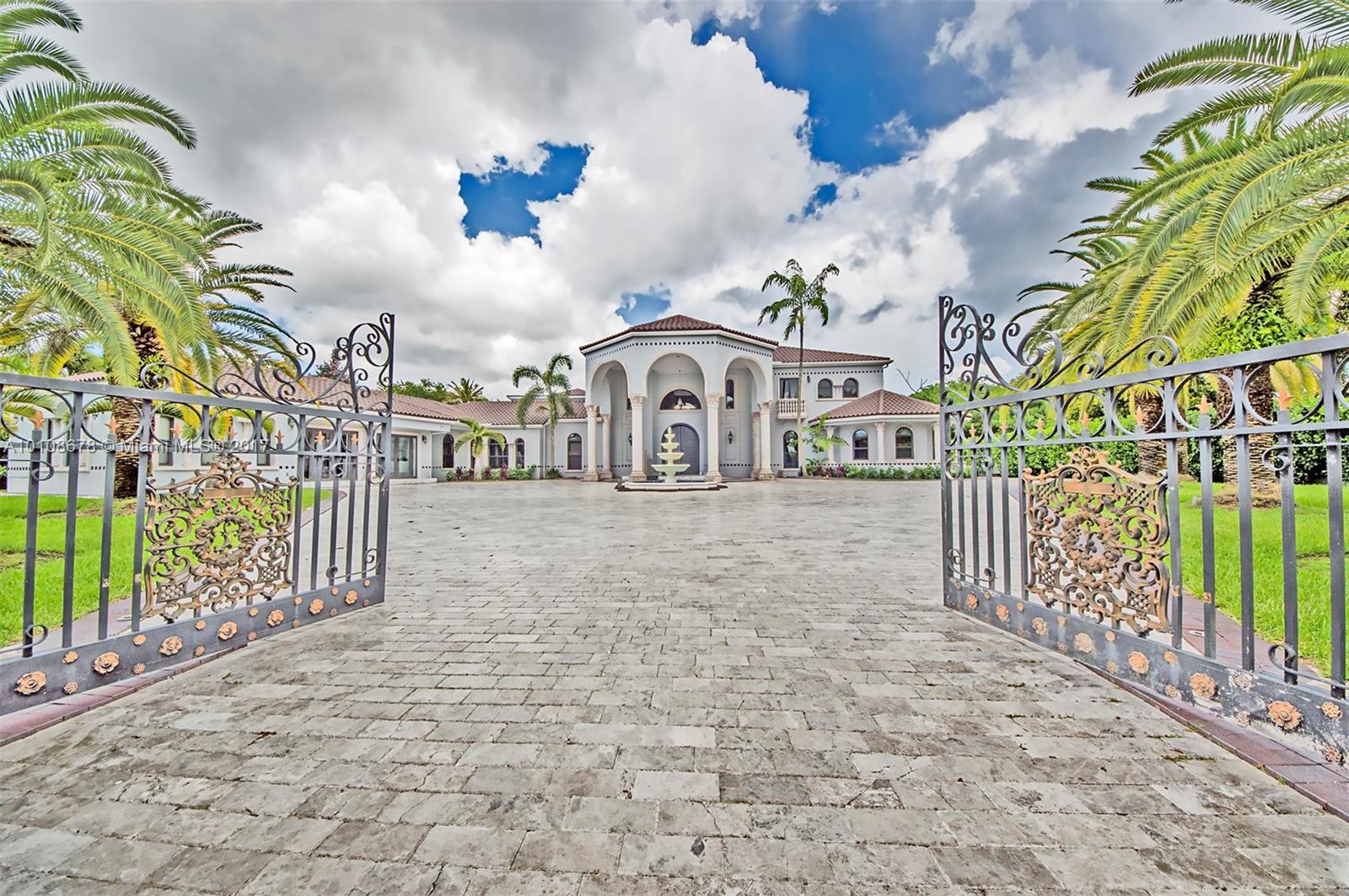 10270 Southwest 58th Street Miami, FL 33173 - Photo 1 of 35 a front view of a house with a garden