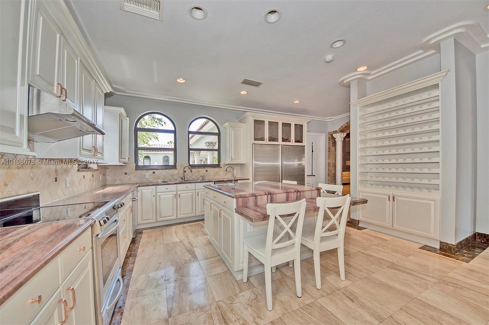 10270 Southwest 58th Street Miami, FL 33173 - Photo 12 of 35 a kitchen with stainless steel appliances granite countertop a stove a sink dishwasher and white cabinets with wooden floor