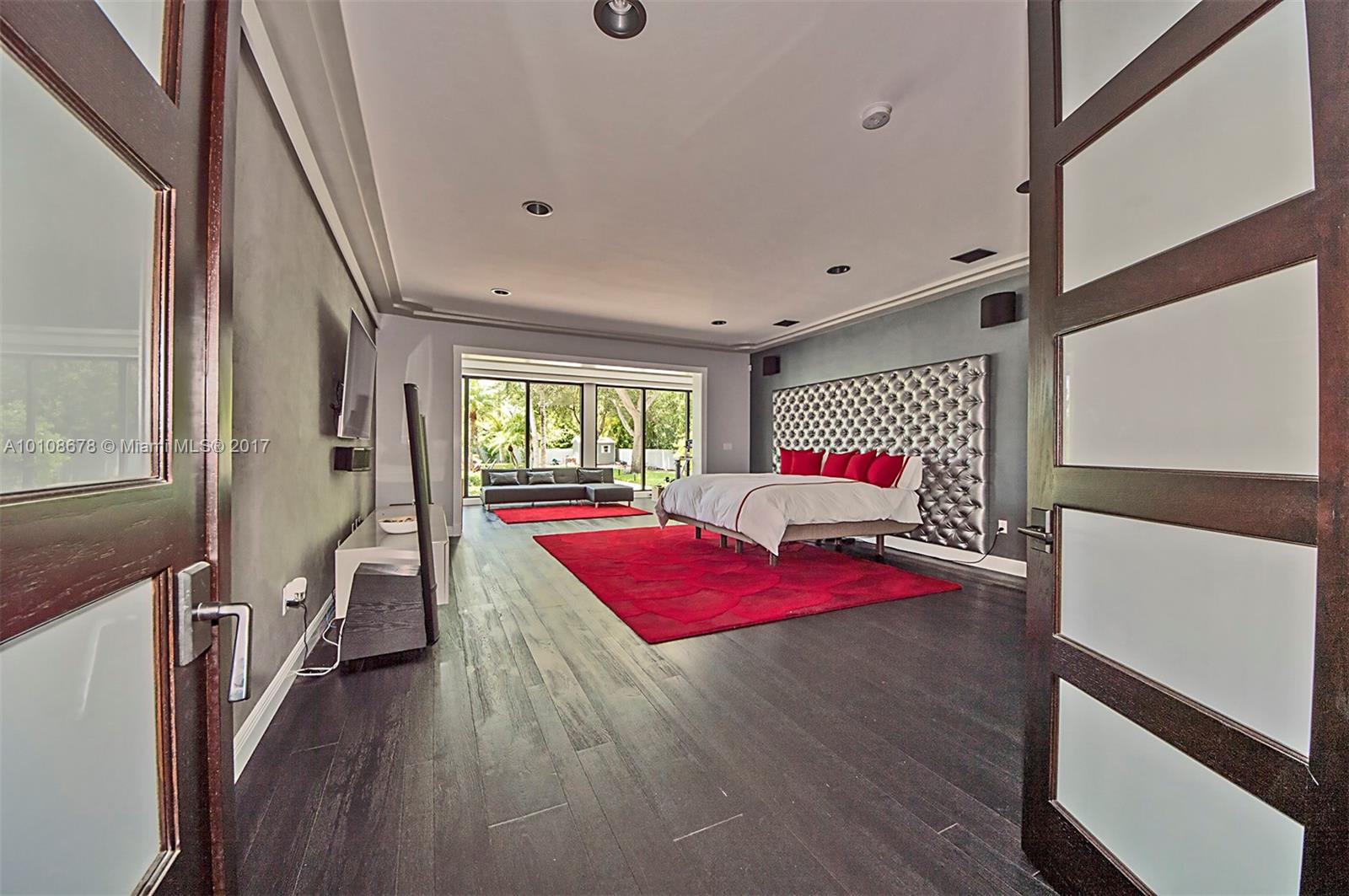 10270 Southwest 58th Street Miami, FL 33173 - Photo 13 of 35 a bedroom with wooden floor and window