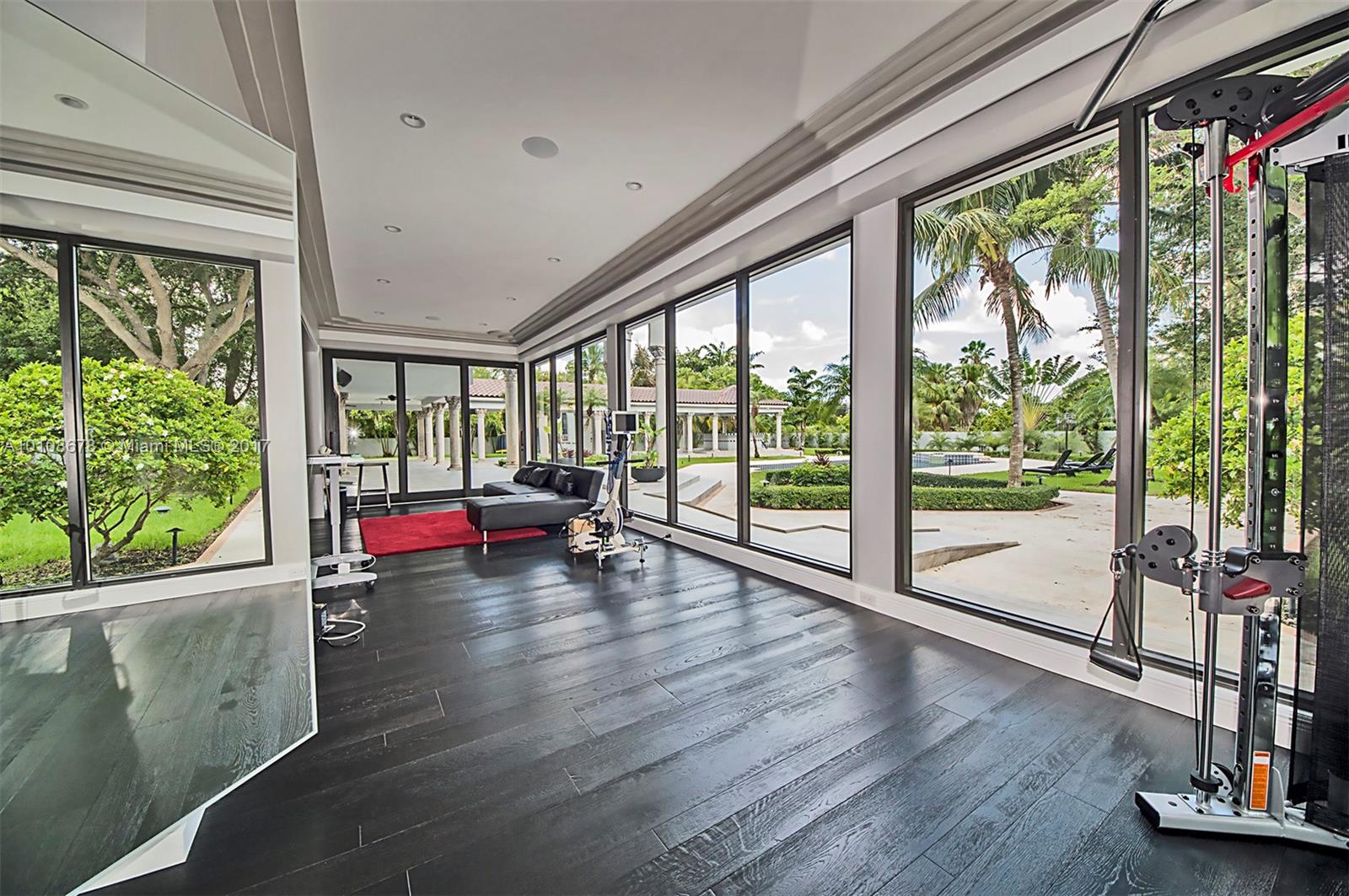 10270 Southwest 58th Street Miami, FL 33173 - Photo 17 of 35 a living room with hardwood floor and large windows