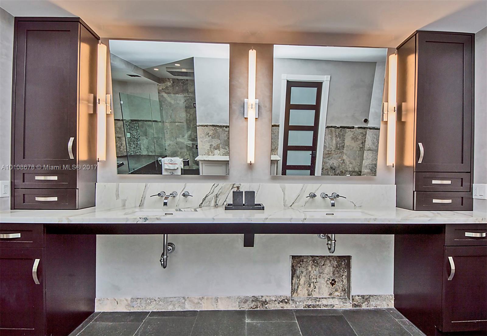 10270 Southwest 58th Street Miami, FL 33173 - Photo 20 of 35 a bathroom with a sink and a mirror