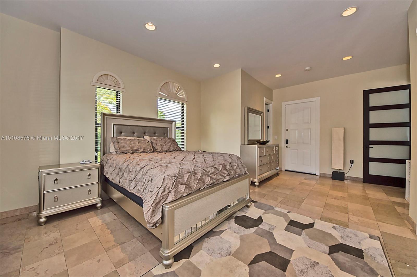 10270 Southwest 58th Street Miami, FL 33173 - Photo 25 of 35 a bedroom with a bed and closet with mirror