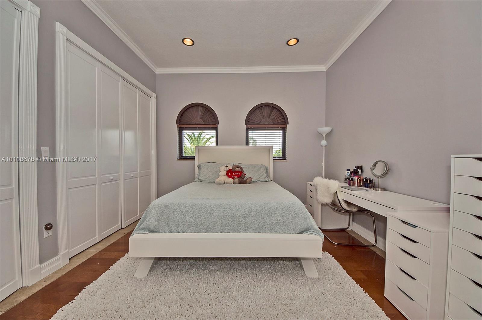 10270 Southwest 58th Street Miami, FL 33173 - Photo 26 of 35 a bed room with a bed and a night stand
