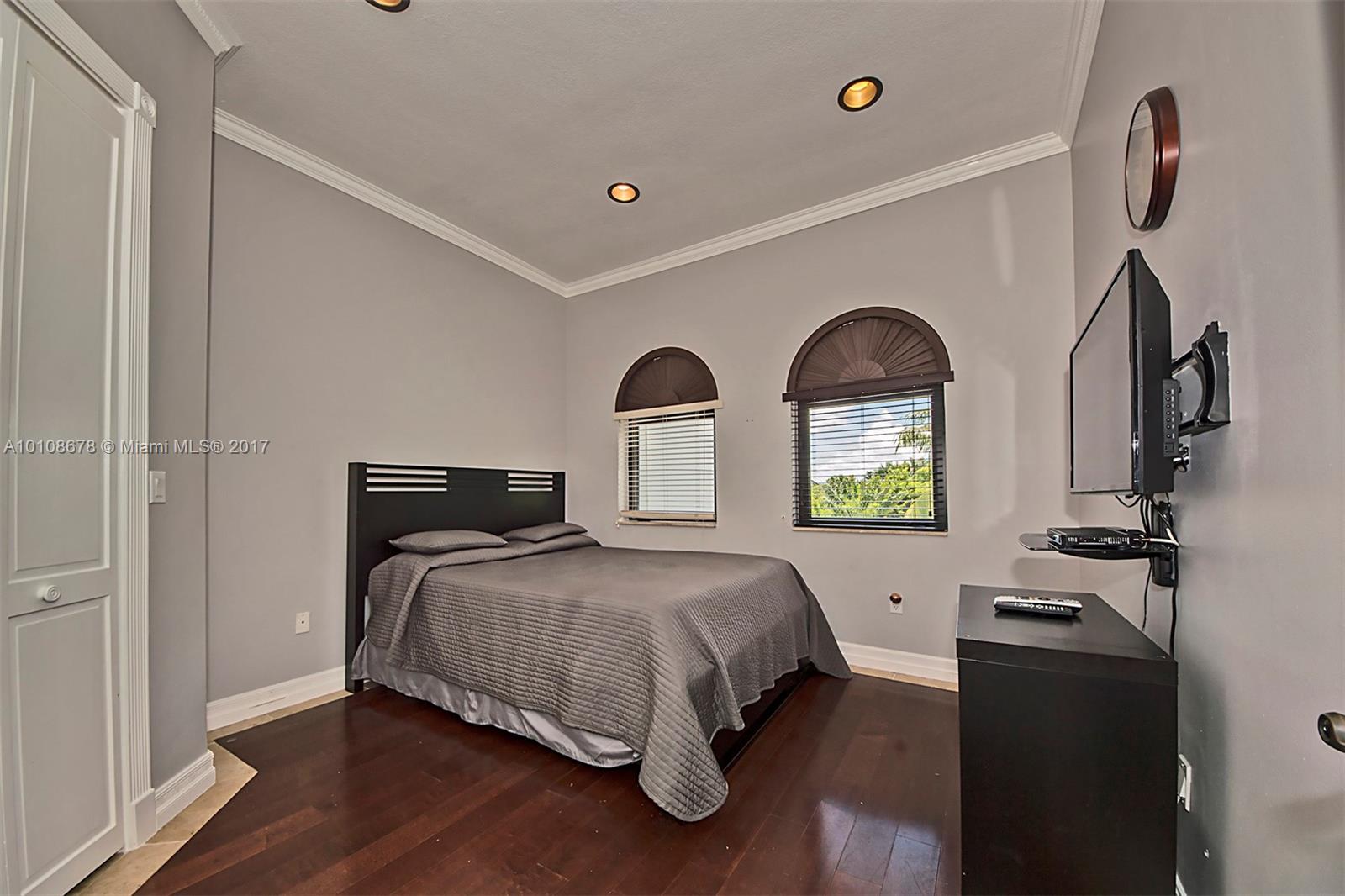 10270 Southwest 58th Street Miami, FL 33173 - Photo 27 of 35 a bedroom with bed and window