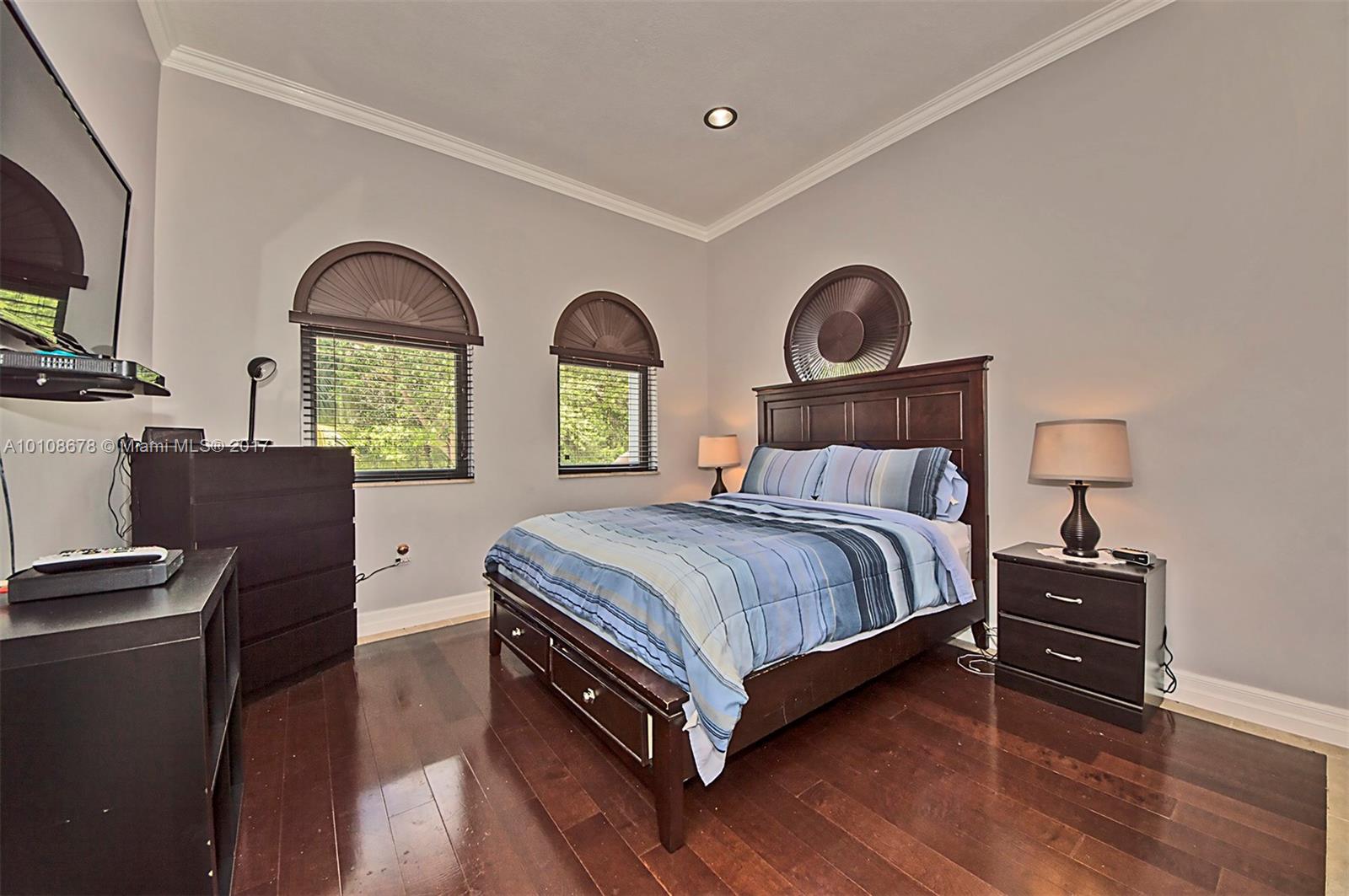 10270 Southwest 58th Street Miami, FL 33173 - Photo 28 of 35 a bedroom with a bed a dresser next to a window