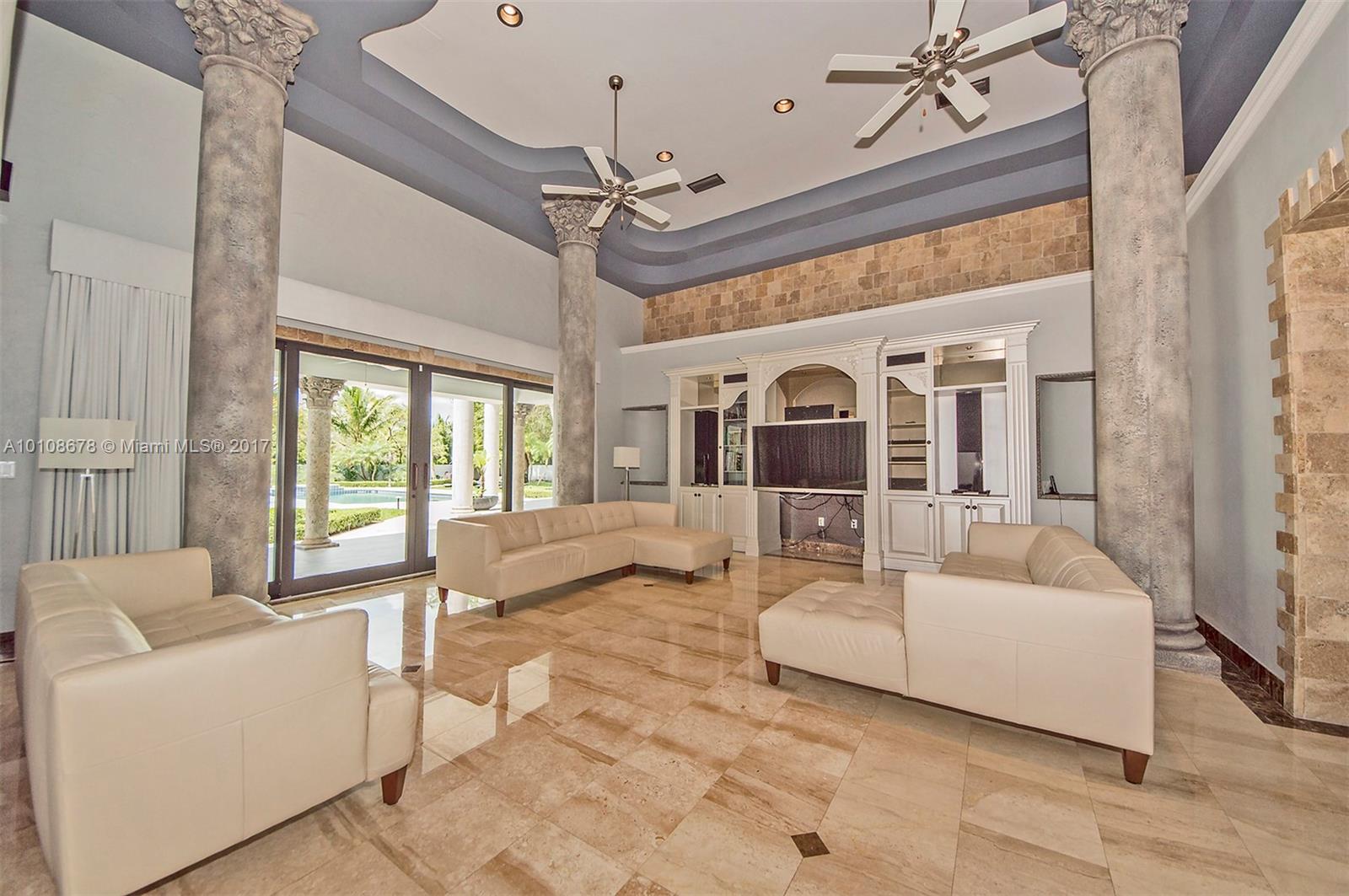10270 Southwest 58th Street Miami, FL 33173 - Photo 10 of 35 a living room with furniture and a chandelier
