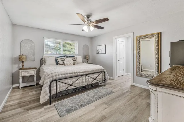 a bedroom with a large bed and a chandelier