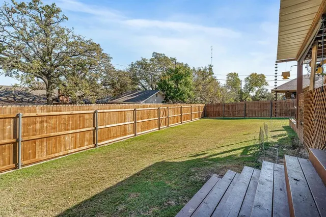 a living room with patio furniture and a fireplace