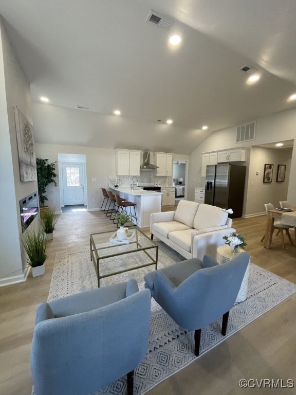 471 Pedro Pitts Road Caret, VA 22436 - Photo 3 of 19 Living room featuring lofted ceiling, light wood-s