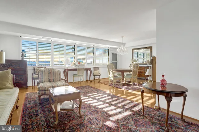 a living room with furniture a rug and kitchen view