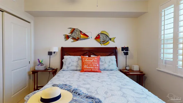 a bedroom with a bed and painting on the wall