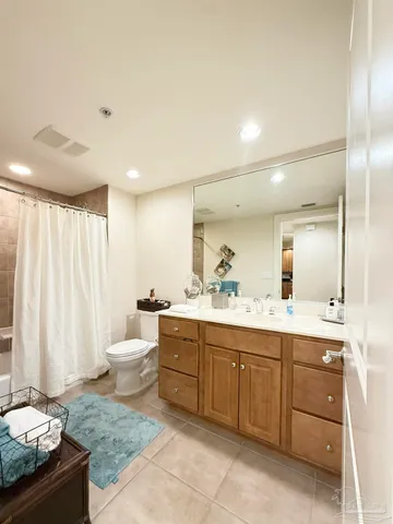 a spacious bathroom with a granite countertop sink and a mirror