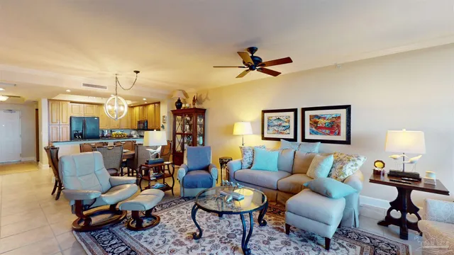 a living room with furniture a rug and a chandelier