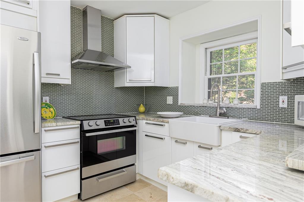 a kitchen with stainless steel appliances granite countertop a stove a sink and a refrigerator