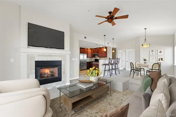 a living room with furniture a flat screen tv and a fireplace