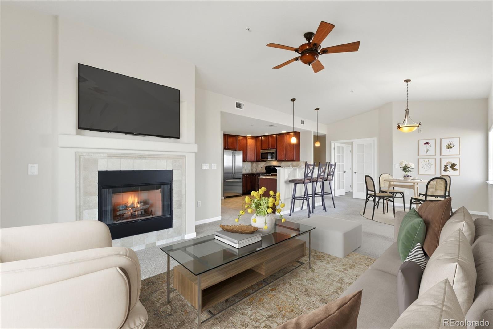 a living room with furniture a flat screen tv and a fireplace
