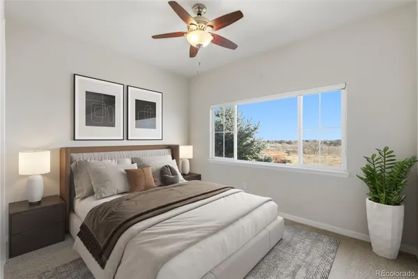 a bedroom with a large bed and a potted plant