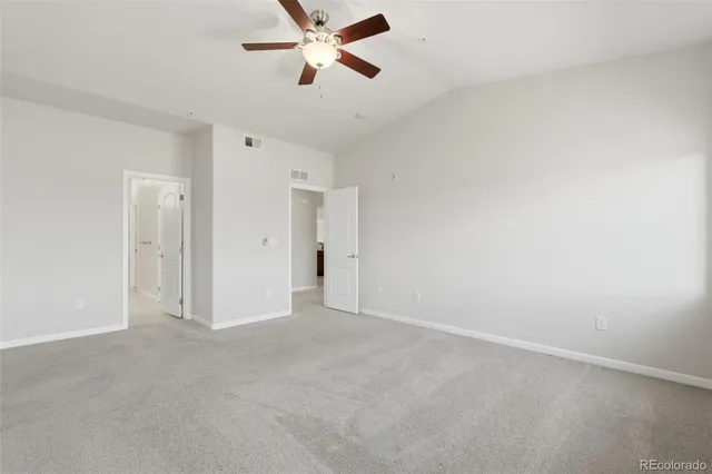 a view of a room with a ceiling fan