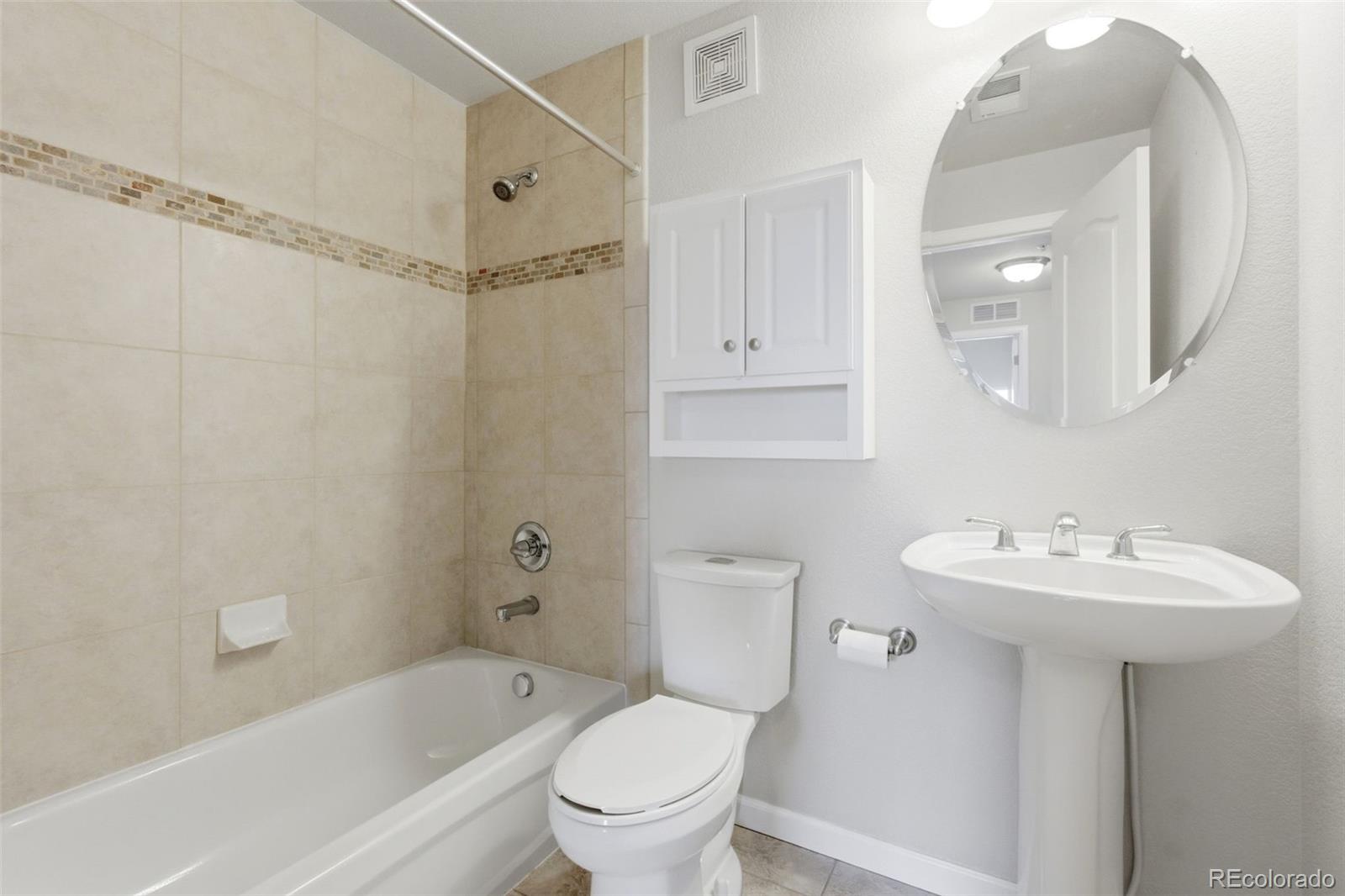 6223 Kilmer Loop, Unit 201 Golden, CO 80403 - Photo 16 of 44 a bathroom with a sink a toilet and shower