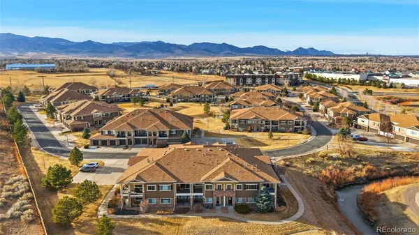 an aerial view of residential houses with outdoor space and river