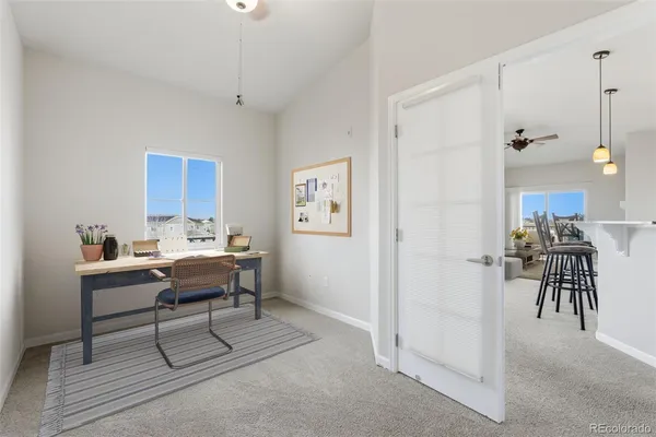 a view of a livingroom with furniture and workspace