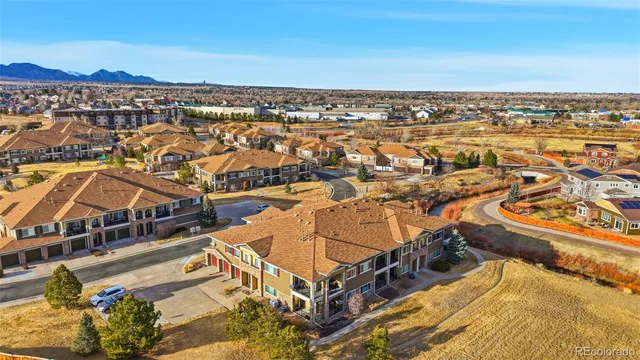 an aerial view of residential houses with outdoor space and river