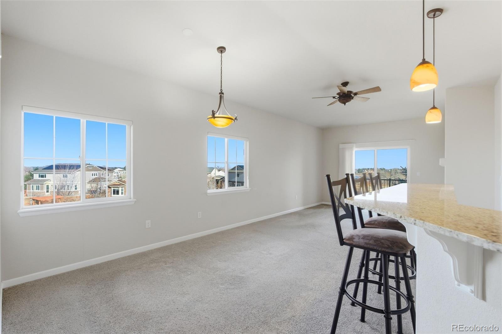 6223 Kilmer Loop, Unit 201 Golden, CO 80403 - Photo 36 of 44 a view of a dining room with furniture and a chandelier