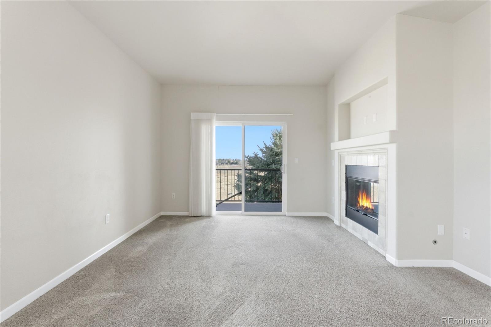 6223 Kilmer Loop, Unit 201 Golden, CO 80403 - Photo 38 of 44 a view of an empty room with a fireplace and a window