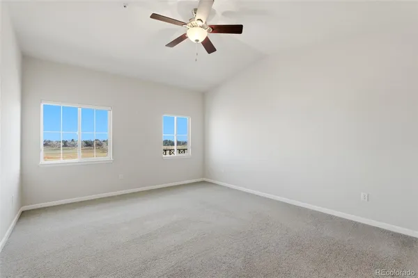 a view of a room with a ceiling fan