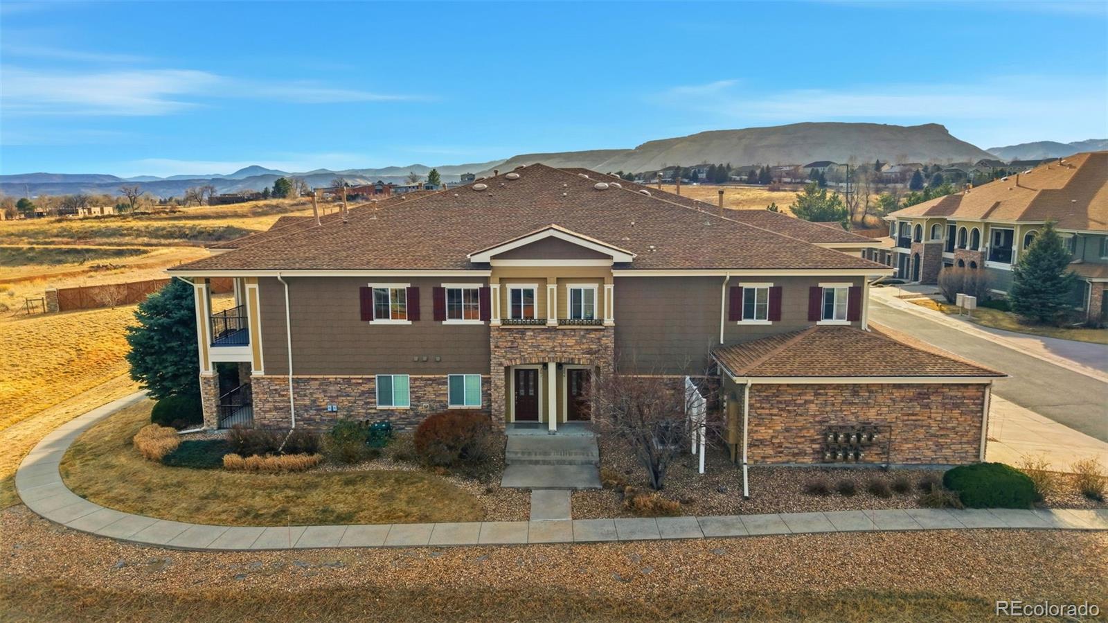 6223 Kilmer Loop, Unit 201 Golden, CO 80403 - Photo 4 of 44 a front view of a house with a yard