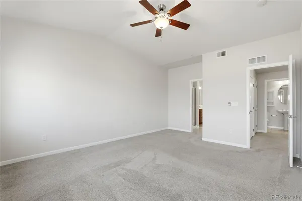 an empty room with a empty space and a ceiling fan