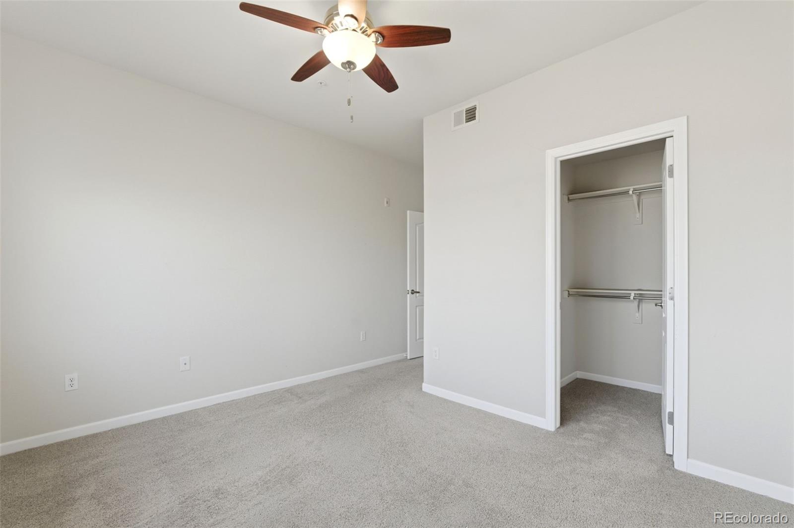 6223 Kilmer Loop, Unit 201 Golden, CO 80403 - Photo 43 of 44 an empty room with a empty space and a ceiling fan