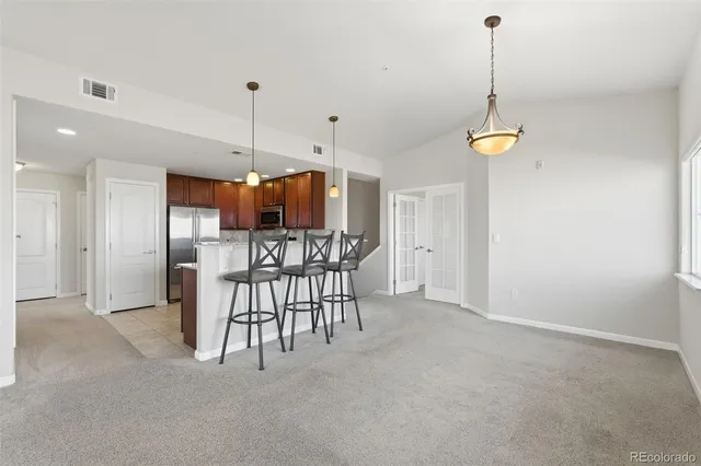 a view of a dining room with furniture and a chandelier
