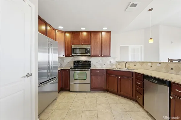 a kitchen with a sink stove and refrigerator