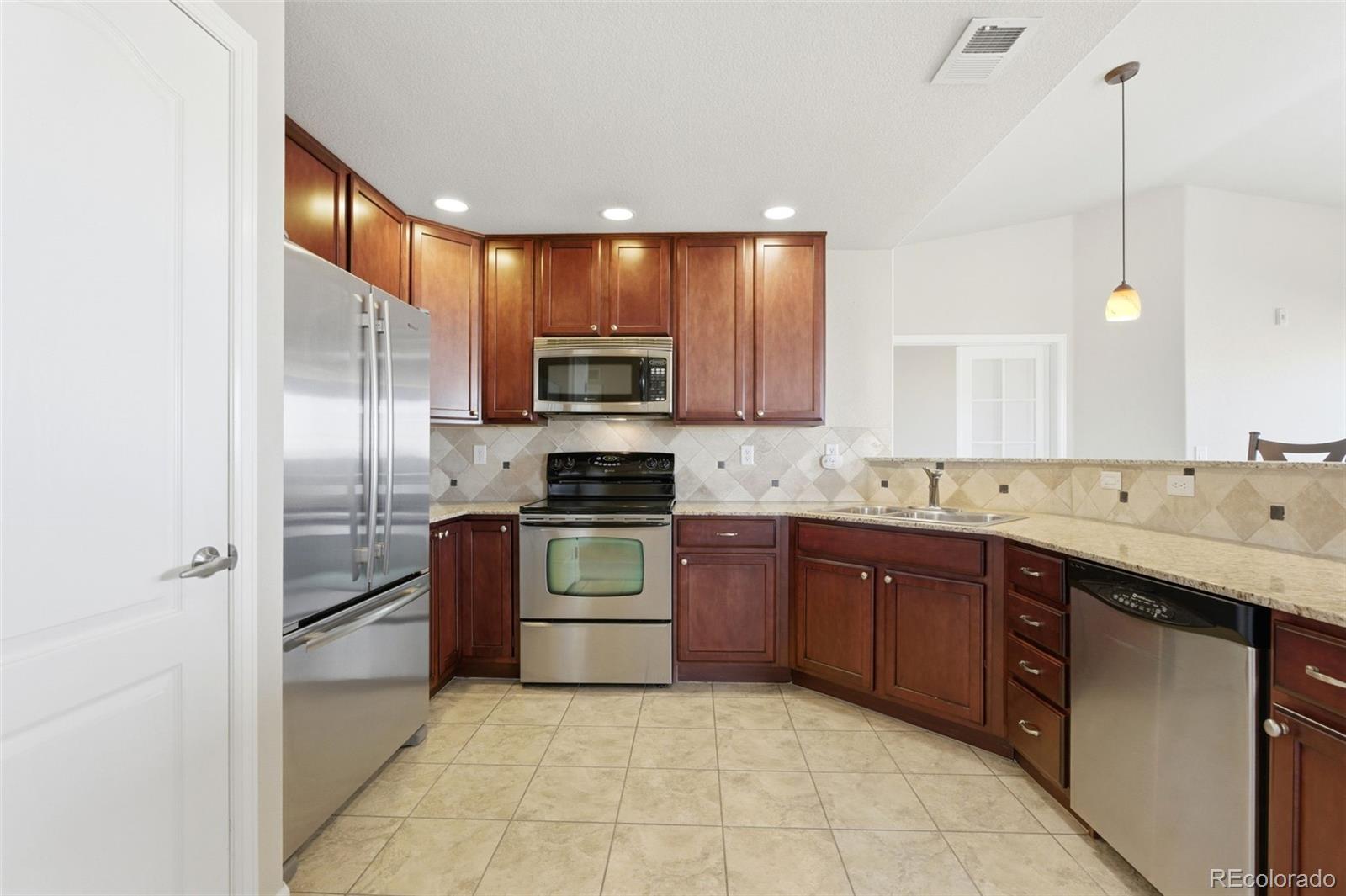 6223 Kilmer Loop, Unit 201 Golden, CO 80403 - Photo 7 of 44 a kitchen with a sink stove and refrigerator