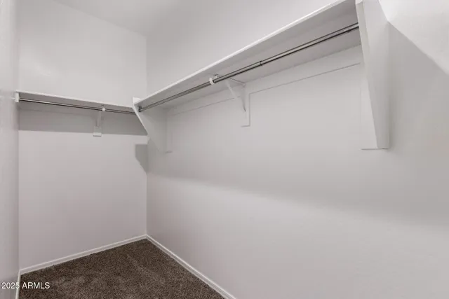 a small walk in closet with a window
