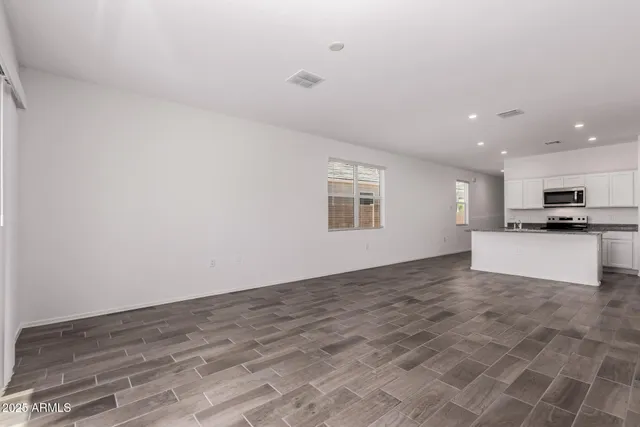 a view of kitchen with kitchen island microwave and stove
